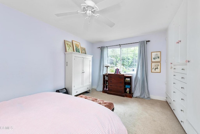 bedroom with baseboards, a ceiling fan, and light colored carpet