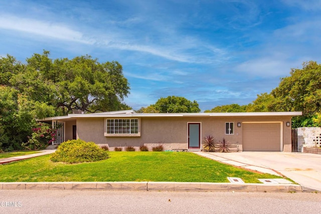 ranch-style house featuring concrete driveway, an attached garage, a front yard, and stucco siding