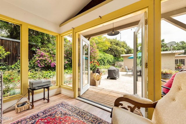 doorway featuring vaulted ceiling and wood finished floors