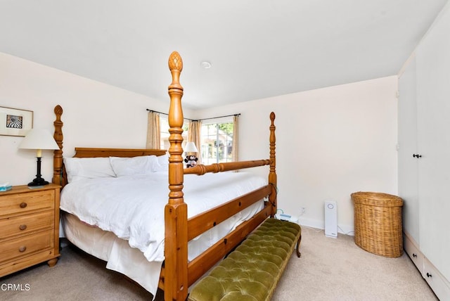 bedroom featuring baseboards and carpet