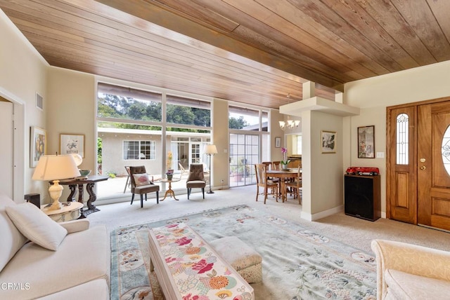 living area with carpet floors, a chandelier, wood ceiling, and visible vents
