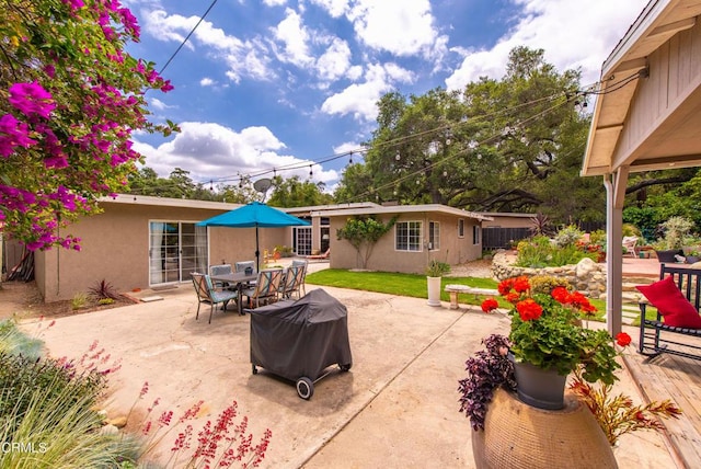 view of patio / terrace with outdoor dining space and a grill