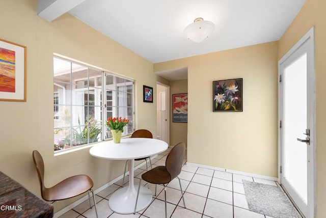 dining room with light tile patterned flooring and baseboards
