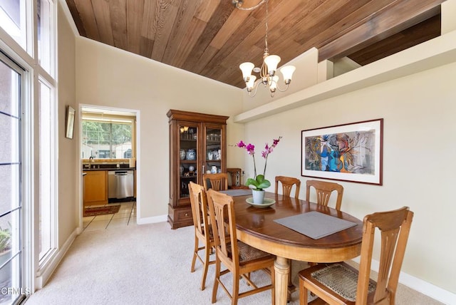 dining area featuring wooden ceiling, baseboards, a notable chandelier, and light carpet