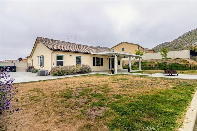 view of front of home with a fire pit, a patio area, and a fenced backyard