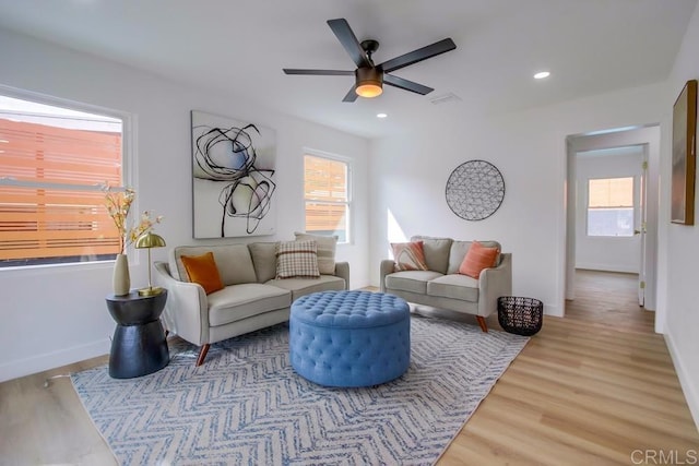 living area featuring healthy amount of natural light, wood finished floors, ceiling fan, and recessed lighting