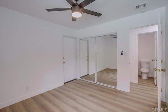 unfurnished bedroom with light wood finished floors, baseboards, a closet, and a ceiling fan