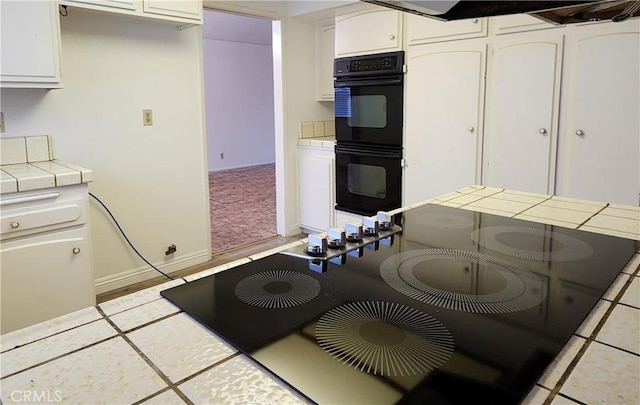 4872 Emerald Ave, La Verne, CA 91750 - kitchen featuring white cabinets, dobule oven black, tile counters, baseboards, and light tile patterned flooring