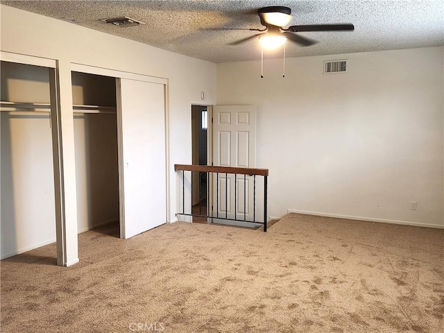 4872 Emerald Ave, La Verne, CA 91750 - unfurnished bedroom with a textured ceiling, visible vents, two closets, and carpet flooring
