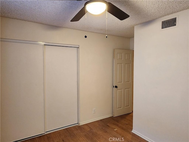 4872 Emerald Ave, La Verne, CA 91750 - unfurnished bedroom featuring wood finished floors, a closet, baseboards, visible vents, and a textured ceiling