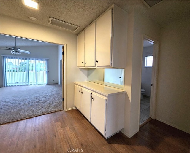 4872 Emerald Ave, La Verne, CA 91750 - kitchen featuring baseboards, white cabinets, wood finished floors, and light countertops