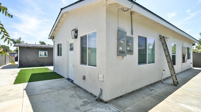 10301 Antigua St, Anaheim, CA 92804 - view of side of property with stucco siding and a patio area