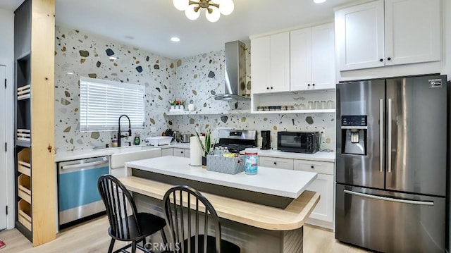 10301 Antigua St, Anaheim, CA 92804 - kitchen with wall chimney range hood, open shelves, a sink, stainless steel appliances, and light countertops