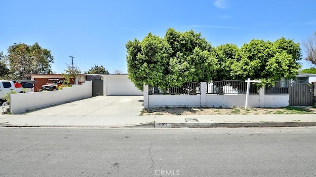 10301 Antigua St, Anaheim, CA 92804 - view of front facade featuring a garage, a fenced front yard, and driveway