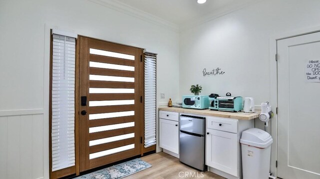 10301 Antigua St, Anaheim, CA 92804 - interior space with white cabinetry, crown molding, light wood-style flooring, butcher block counters, and refrigerator