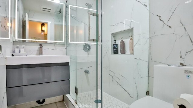10301 Antigua St, Anaheim, CA 92804 - full bathroom featuring vanity, toilet, and a marble finish shower