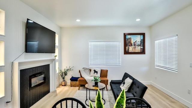 10301 Antigua St, Anaheim, CA 92804 - living area featuring recessed lighting, baseboards, wood finished floors, and a glass covered fireplace