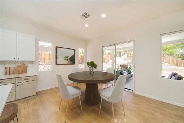dining space with recessed lighting, visible vents, light wood-style flooring, and baseboards