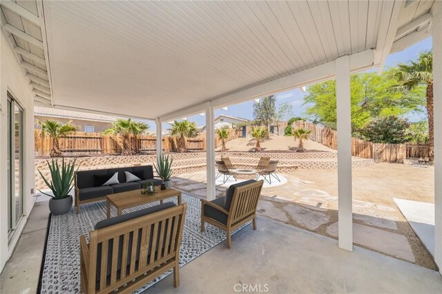 view of patio / terrace featuring an outdoor hangout area and a fenced backyard