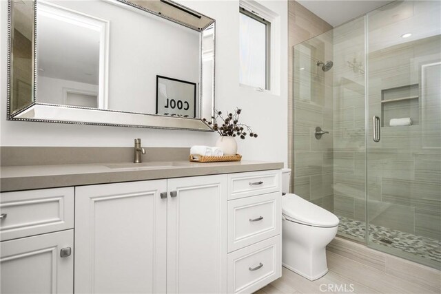 full bath with toilet, a shower stall, and vanity