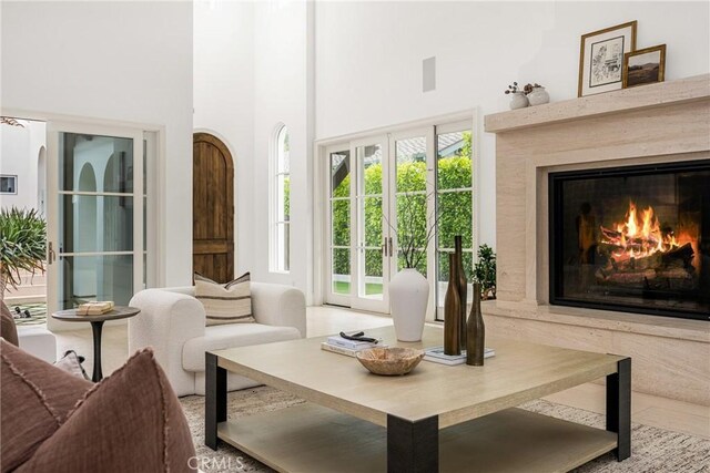 sitting room featuring a high ceiling and a fireplace
