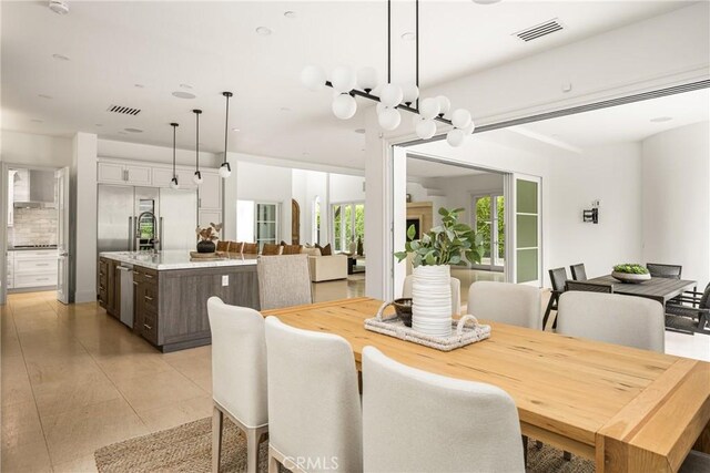 dining area with visible vents and light tile patterned flooring
