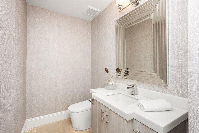 bathroom with vanity, visible vents, toilet, baseboards, and tile patterned floors