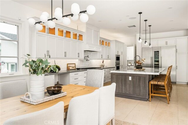 dining room featuring light tile patterned flooring and visible vents
