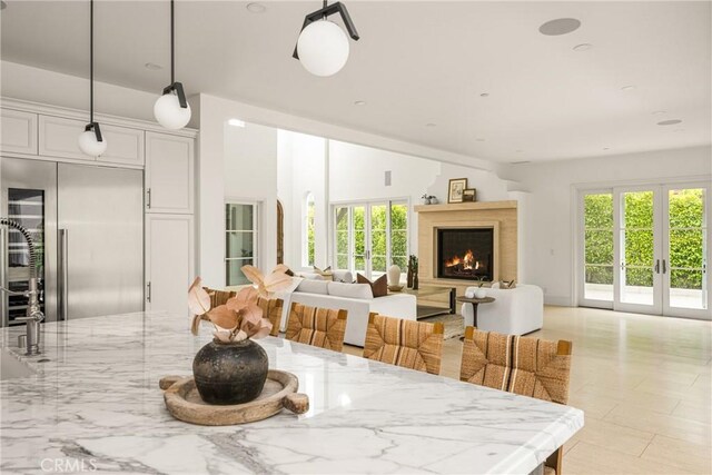 dining space with plenty of natural light and a lit fireplace
