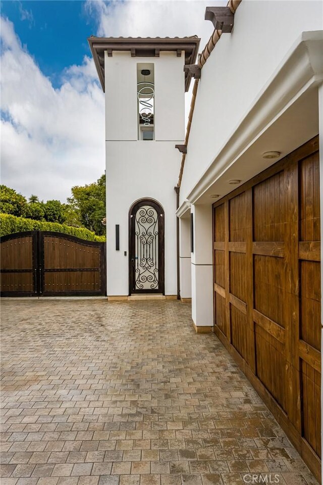 view of home's exterior featuring a gate and stucco siding