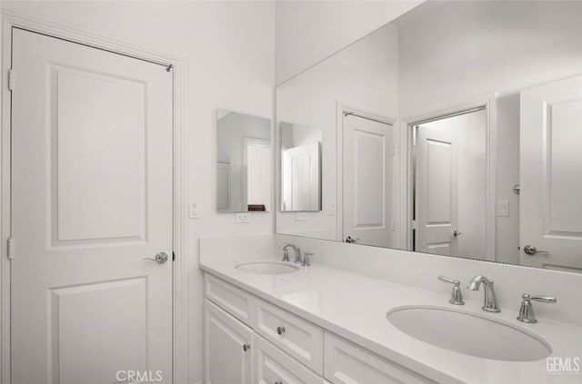 bathroom with double vanity and a sink