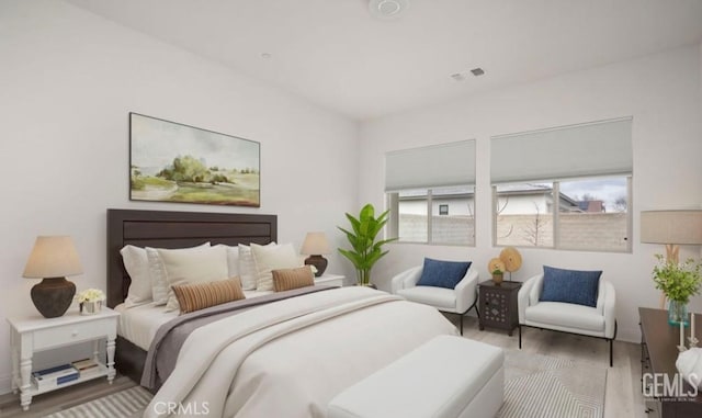 bedroom featuring wood finished floors and visible vents
