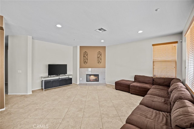 living room with tile patterned floors, a fireplace, recessed lighting, and visible vents