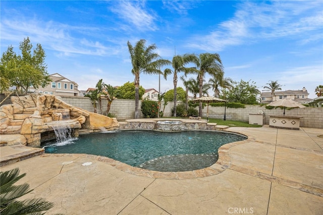 view of pool featuring a pool with connected hot tub, a water slide, a fenced backyard, and a patio area