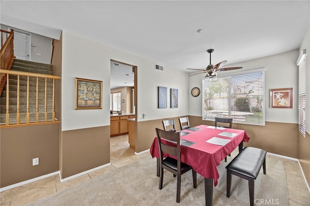 dining room featuring visible vents, ceiling fan, a healthy amount of sunlight, and stairway