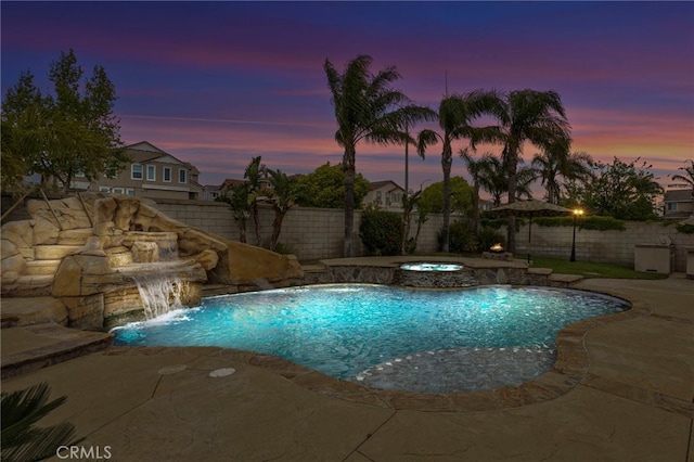 pool at dusk with a patio, a fenced in pool, and a fenced backyard
