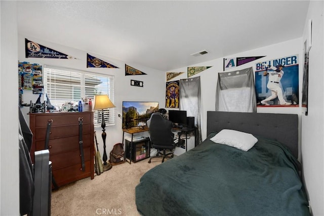 bedroom with visible vents, lofted ceiling, and carpet