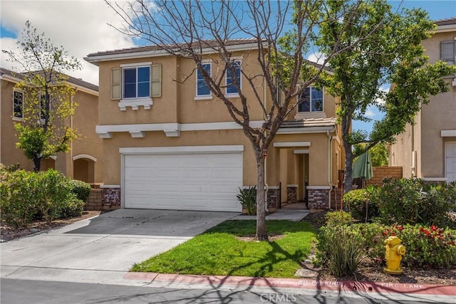 view of front of property with driveway, a garage, and stucco siding