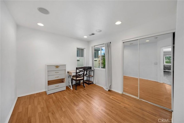 office with light wood finished floors, recessed lighting, visible vents, and baseboards