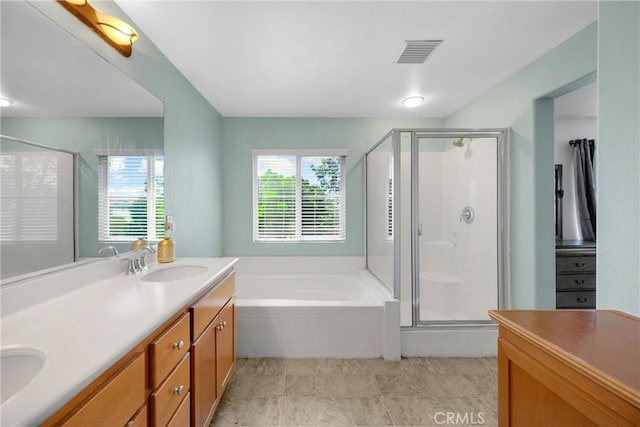 full bathroom featuring double vanity, a sink, a shower stall, and visible vents