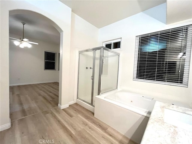 22810 Mountain Ash Cir, Corona, CA 92883 - bathroom with a stall shower, a jetted tub, a ceiling fan, and wood finished floors