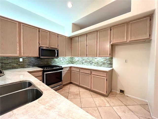 22810 Mountain Ash Cir, Corona, CA 92883 - kitchen featuring a sink, decorative backsplash, light tile patterned floors, light brown cabinetry, and appliances with stainless steel finishes