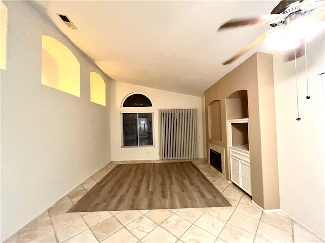 22810 Mountain Ash Cir, Corona, CA 92883 - unfurnished living room featuring a tile fireplace, ceiling fan, built in features, tile patterned floors, and lofted ceiling