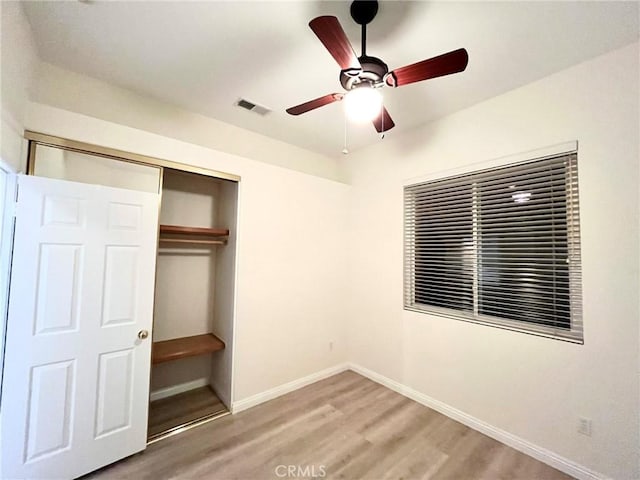 22810 Mountain Ash Cir, Corona, CA 92883 - unfurnished bedroom with light wood-style flooring, a closet, baseboards, visible vents, and a ceiling fan
