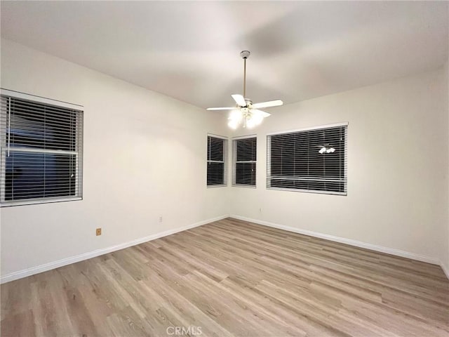 22810 Mountain Ash Cir, Corona, CA 92883 - spare room featuring a ceiling fan, light wood finished floors, and baseboards