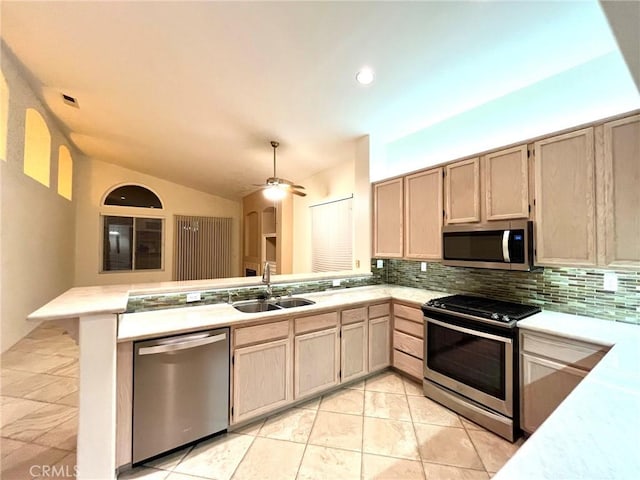 22810 Mountain Ash Cir, Corona, CA 92883 - kitchen with stainless steel appliances, light countertops, a peninsula, and a sink