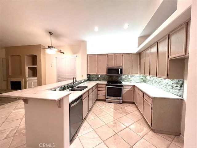 22810 Mountain Ash Cir, Corona, CA 92883 - kitchen with a peninsula, appliances with stainless steel finishes, light countertops, and a sink