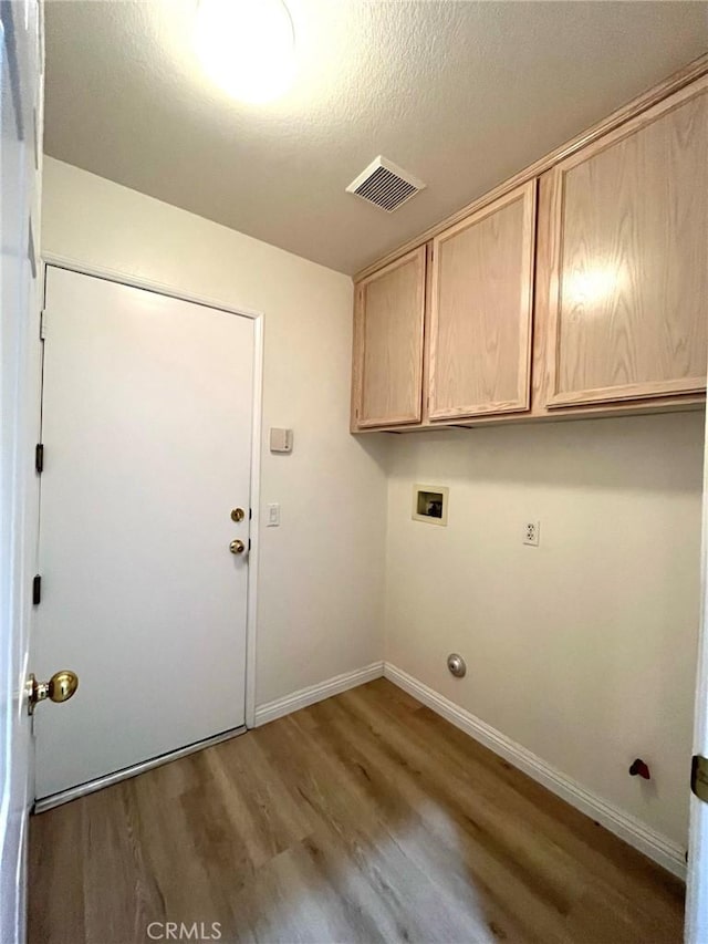 22810 Mountain Ash Cir, Corona, CA 92883 - laundry room with cabinet space, hookup for a washing machine, visible vents, baseboards, and wood finished floors