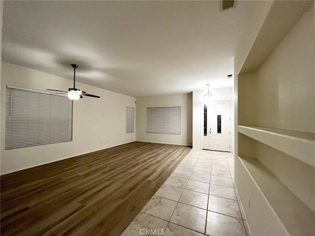 22810 Mountain Ash Cir, Corona, CA 92883 - unfurnished living room with visible vents, wood finished floors, and ceiling fan