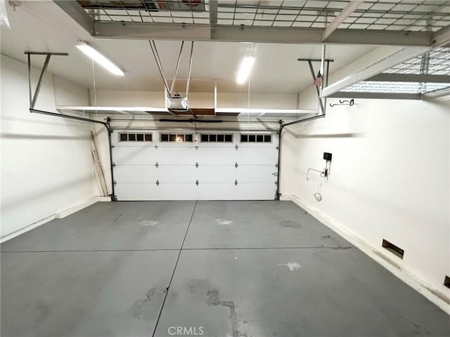 22810 Mountain Ash Cir, Corona, CA 92883 - garage featuring a garage door opener and baseboards
